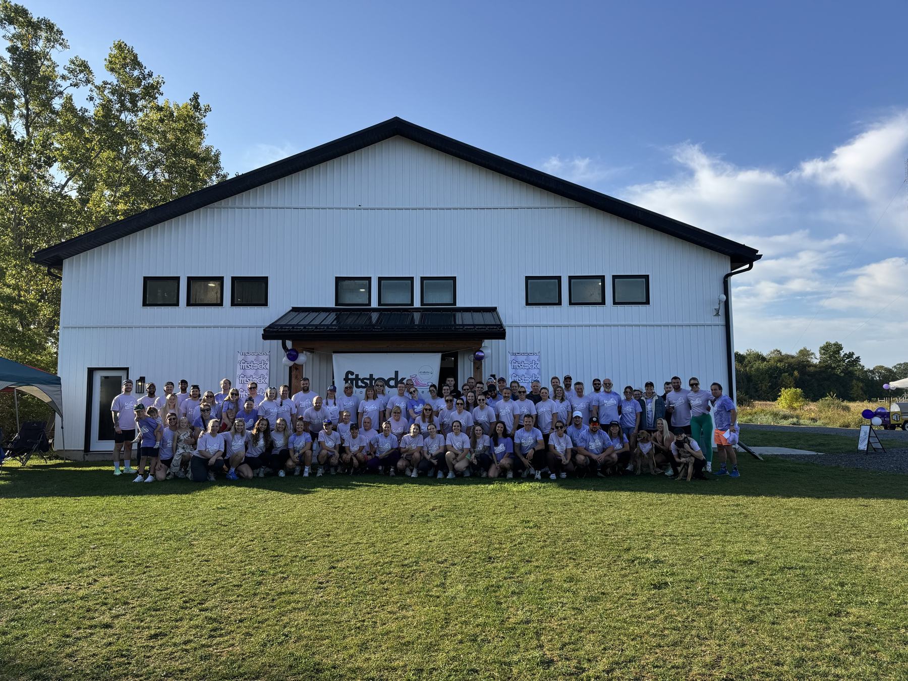 The FITSTOCK crew in lavender shirts in front of The Yard