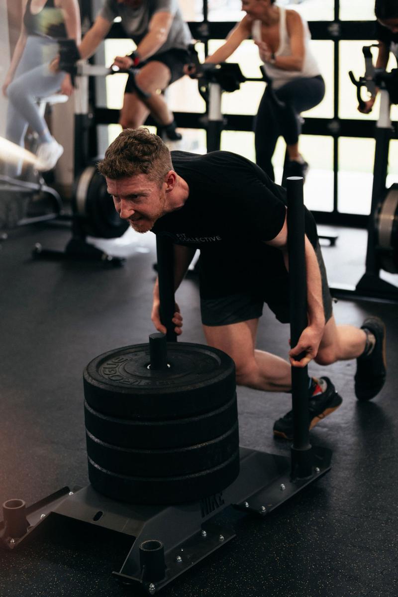 Member pushing a loaded sled