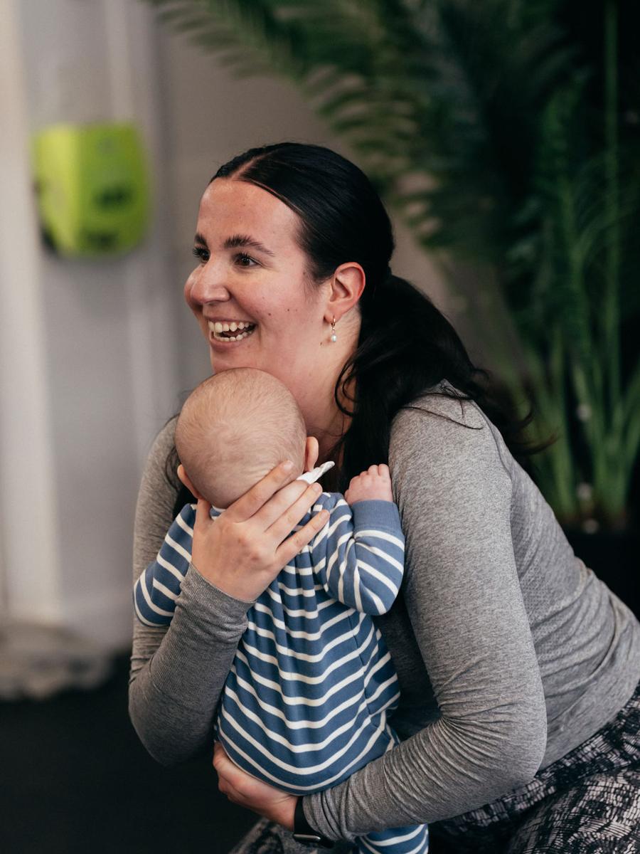 Mom holding her baby at the gym